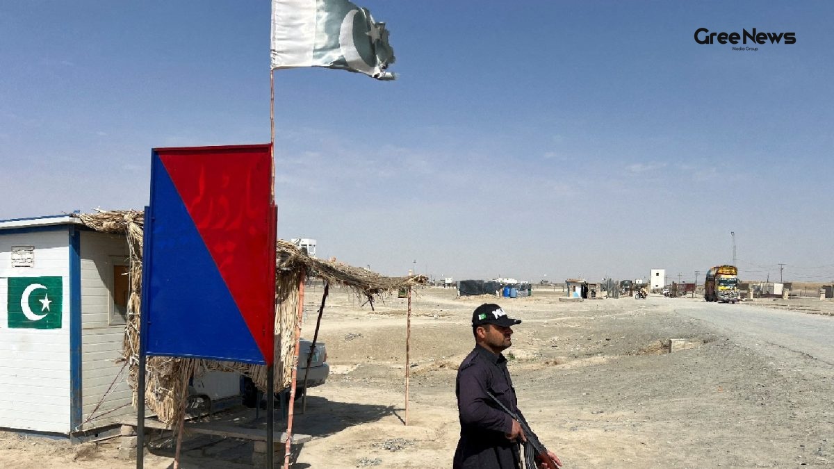Pakistani police officer standing near a barricade